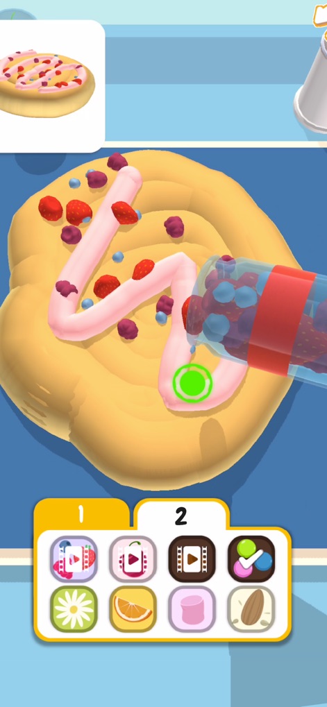 Bake it - Discover the engaging process of adding diverse toppings from a clear dispenser and navigating through multiple pages of ingredient options to perfect each creation.