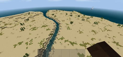Survivalcraft 2 - The game features diverse and vast biomes, illustrated by a winding river cutting through an arid desert landscape with distant ocean vistas.