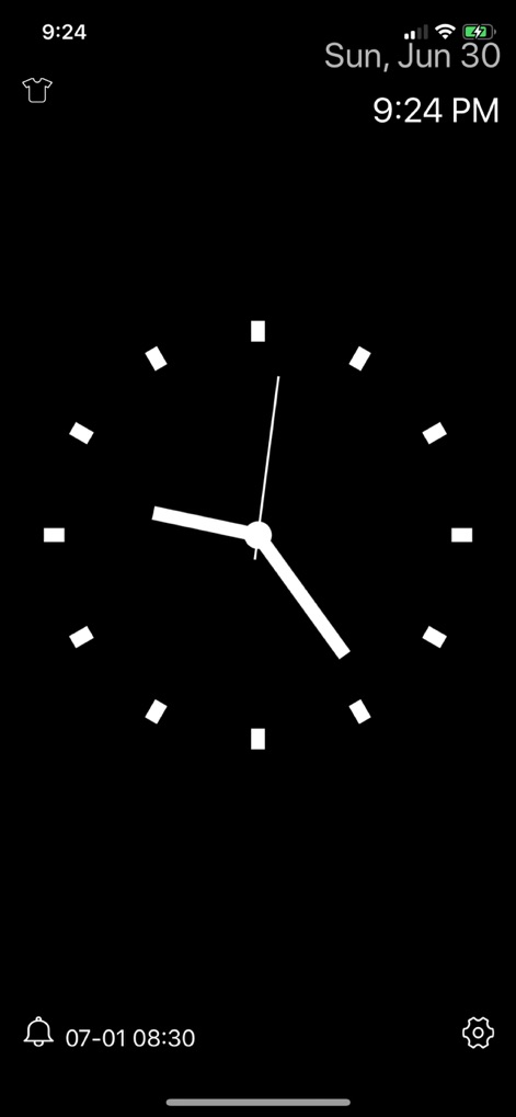 Desk Clock - Analog Clock Face - The app provides a minimalist full-screen clock for bedside use, displaying essential information like the current date and an active alarm setting.