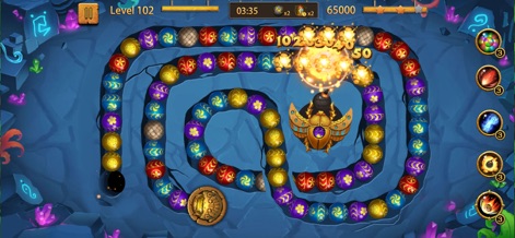 Jungle Blast - Bubble Shooter - Observez l'utilisation stratégique de la bombe pour dégager des groupes de billes dans un environnement souterrain captivant, parsemé de cristaux lumineux.