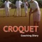 Croquet is a sport that involves hitting wooden or plastic balls with a mallet through hoops embedded in a grass playing court