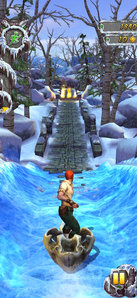 Temple Run 2: Endless Escape - Players can experience the thrill of navigating challenging water rapids on a skull sled, set against a stunning snowy backdrop with glowing torches.