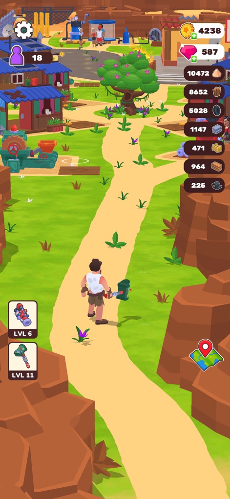 Wasteland Life: Survival Idle - Esta vista panorámica revela el asentamiento en plena expansión con edificios coloridos y variados, y un camino de tierra que serpentea por el paisaje.