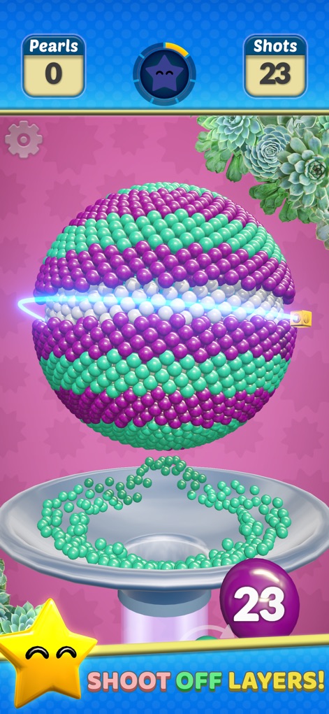 Pearl Gem! - Esta captura destaca la mecánica de eliminar capas con un disparo preciso y la animación de las perlas cayendo en la bandeja inferior, mostrando el progreso del nivel.