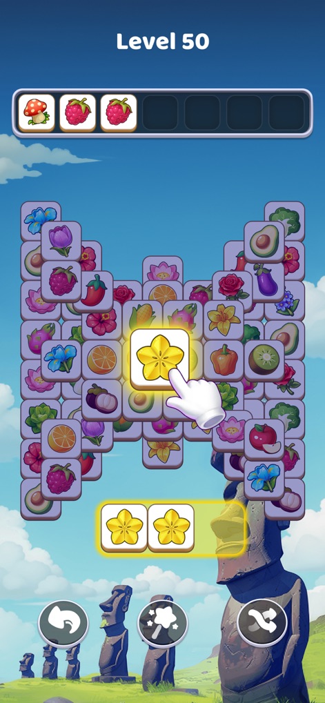 Tile Explorer: Tiles Clear! - The app challenges players with advanced level complexity, evident in 'Level 50', set against stunning global landmarks like the mysterious Easter Island statues.
