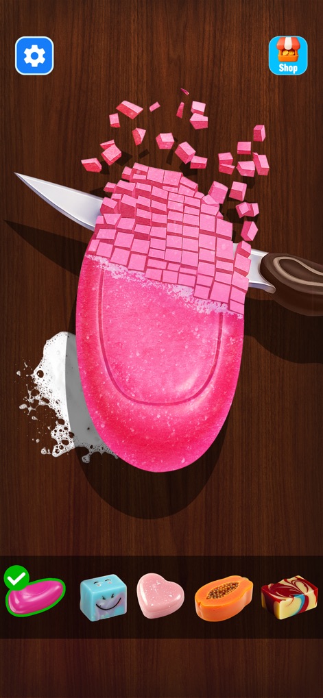 Antistress: Relaxing Mini Game - This scene captures the satisfying process of slicing pink soap into numerous cubes, while offering a selection of diverse soap shapes for continued sensory enjoyment.