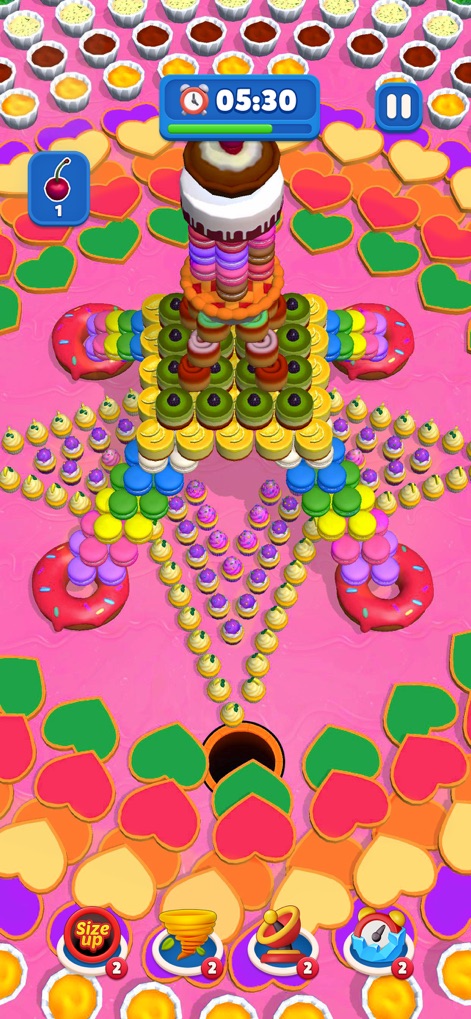 Ever Eater 3D - Observa-se uma variedade de delícias confeitadas e donuts coloridos que cercam o buraco negro, com um bolo multicamadas central esperando para ser consumido nesta fase.