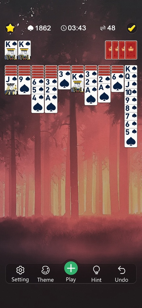 Classic Spider Solitaire Mania - Explore the app's robust customization options, featuring a captivating dark forest background and elegant custom card backs for a unique play environment.