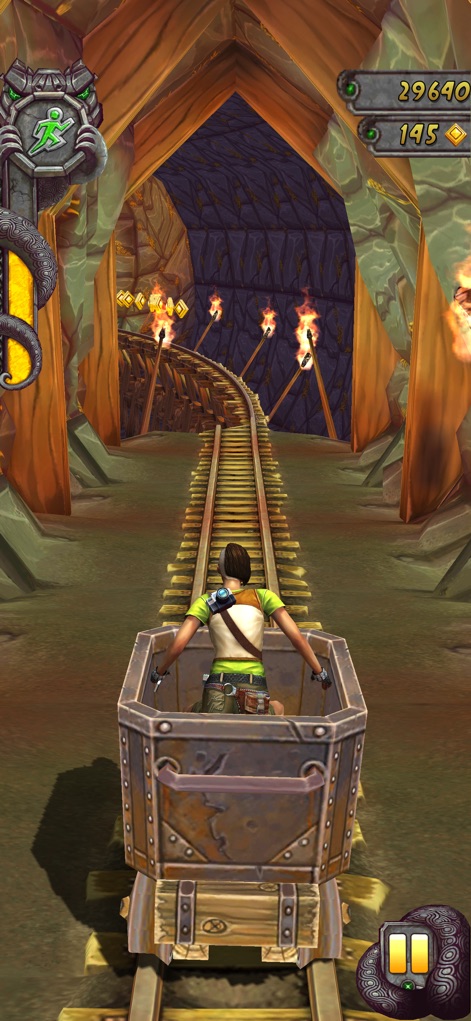 Temple Run 2: Endless Escape - Experience the intense mine cart sequence, where players collect floating gold coins while navigating a torch-lit underground passage.