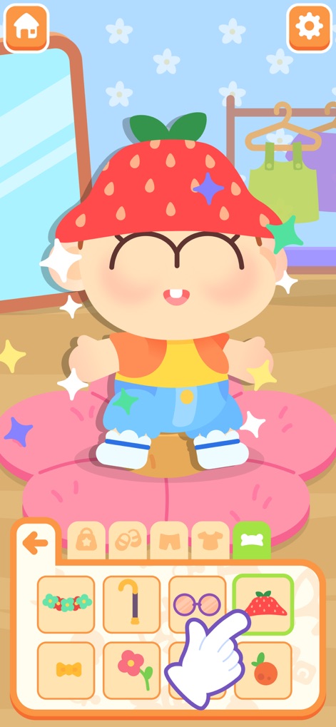 Mother Simulator - Baby Care - The app allows users to customize their baby's look, showing a baby adorned with a fun strawberry hat and a range of clothing options.