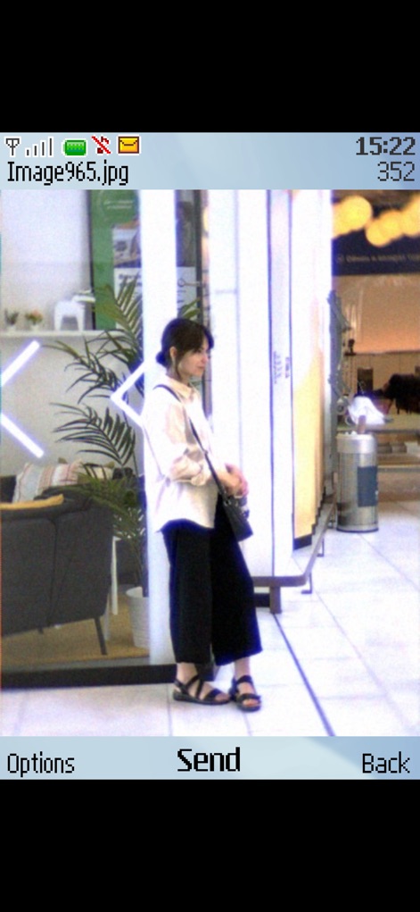 0.3MP Camera - The interface allows users to view captured photos like "Image965.jpg" and easily utilize the "Send" option, mimicking the sharing capabilities of early 2000s phones.