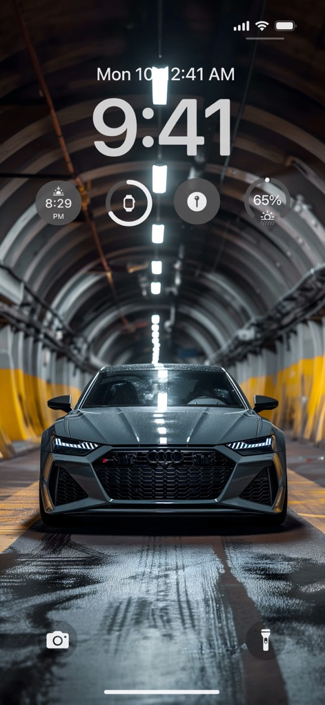 Cone AI Wallpapers 4K & 6К HD - This image presents a sophisticated gray car centered in a modern tunnel, emphasizing both its sleek design and the ambient lighting reflected on the wet ground.