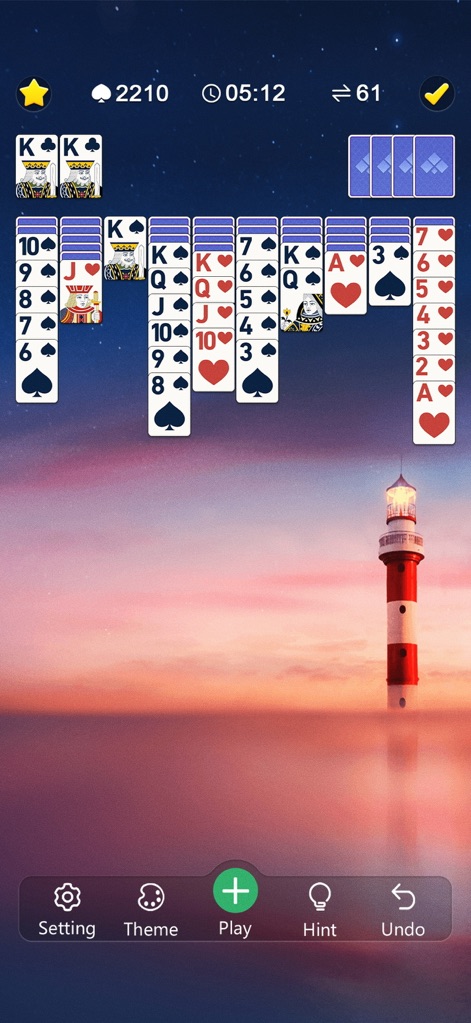 Classic Spider Solitaire Mania - Immerse yourself in diverse visual settings, such as this stunning sunset lighthouse background, complemented by appealing alternative card back designs.