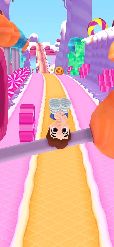 Kooply Run™: Play and Create! - Dive into a sugary world where the character dodges colorful candy obstacles on a vibrant Candyland-themed path.
