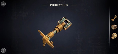 Boxes: Lost Fragments - Uma chave complexa é exibida em close-up, destacando seu design metálico detalhado e uma clara estética de chave steampunk, essencial para desvendar os próximos segredos do jogo.